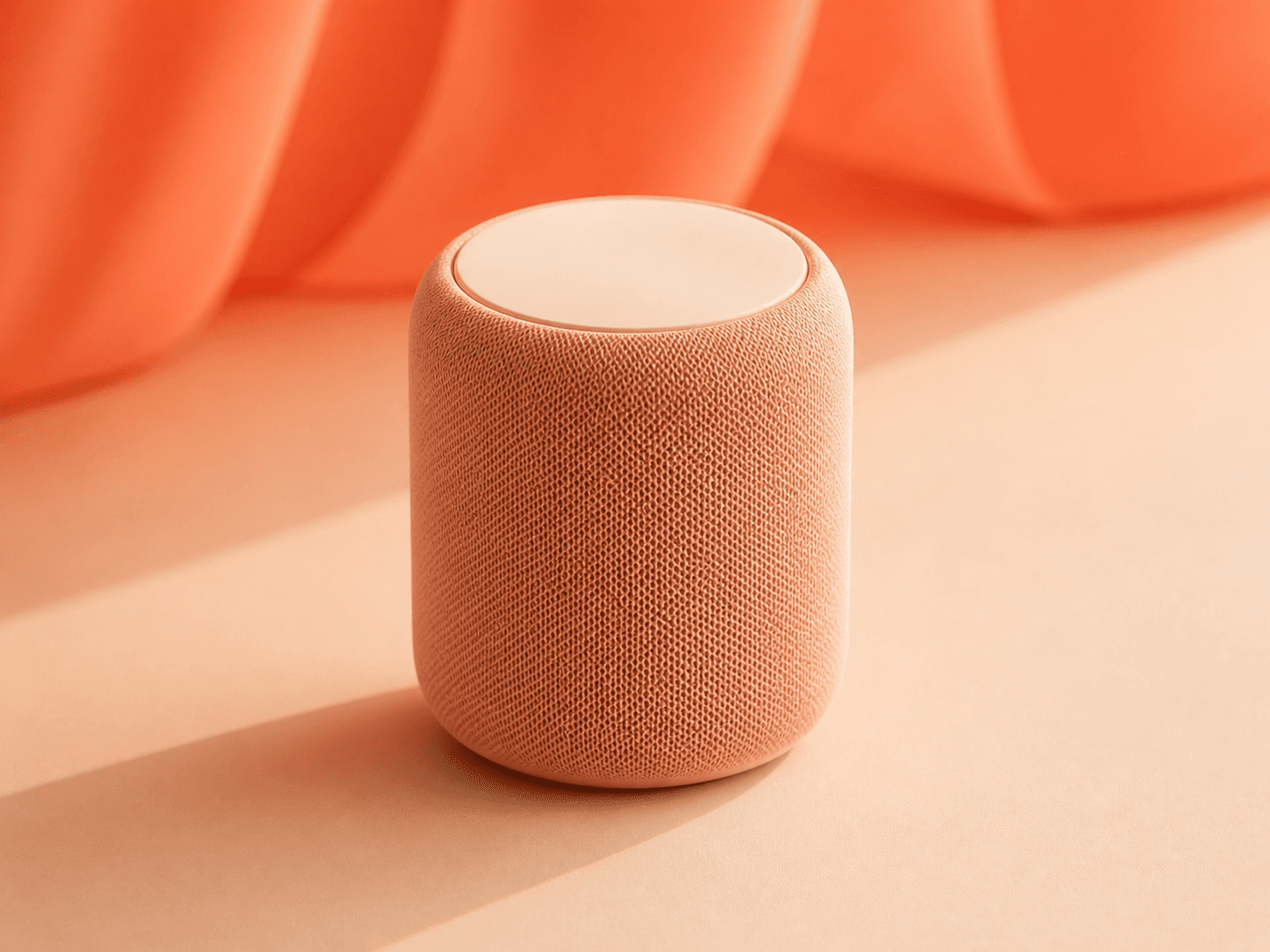Coral-toned smart home speaker on a warm peach surface